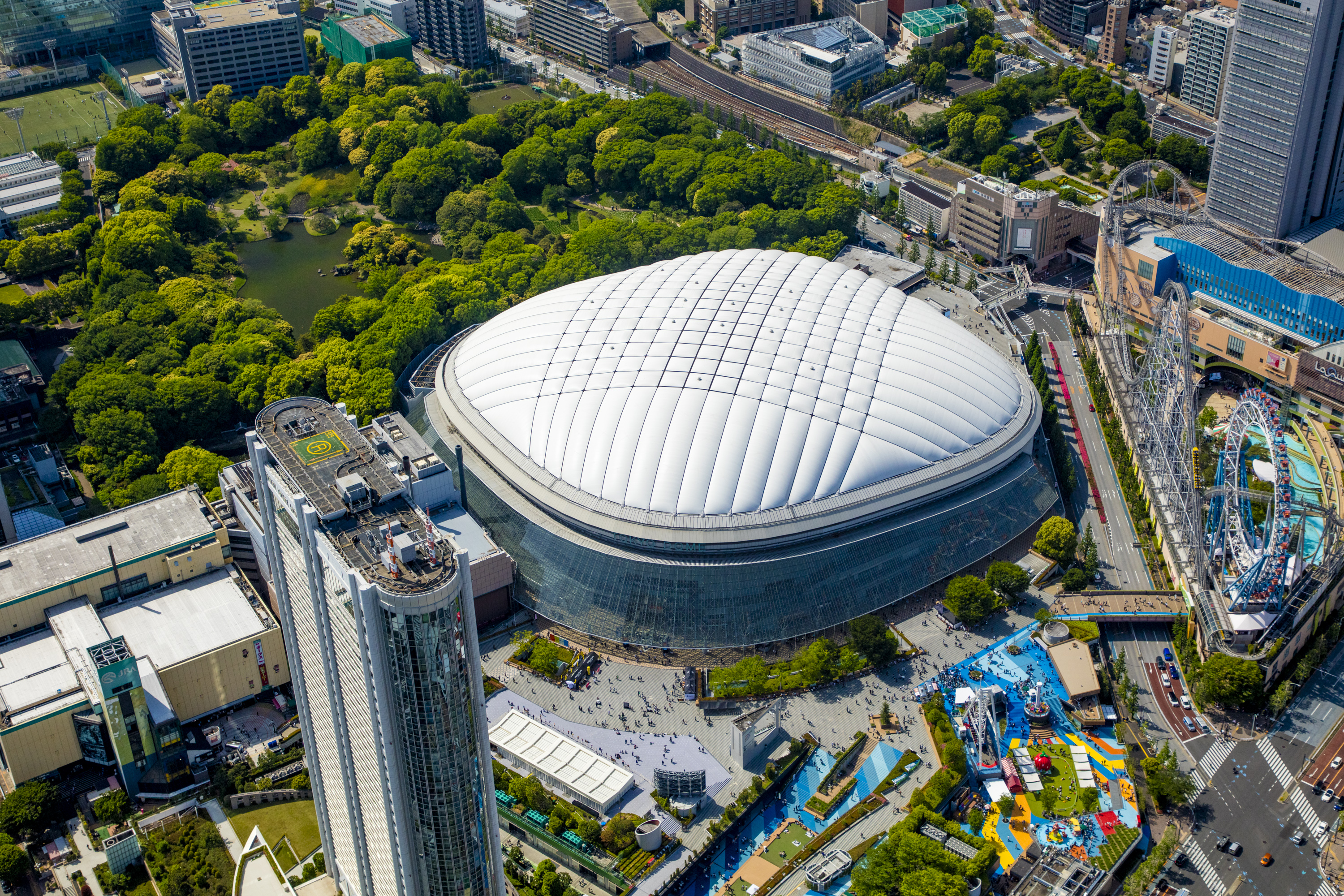 Tokyo Dome City aerial view showing the iconic stadium, amusement park, and entertainment complex